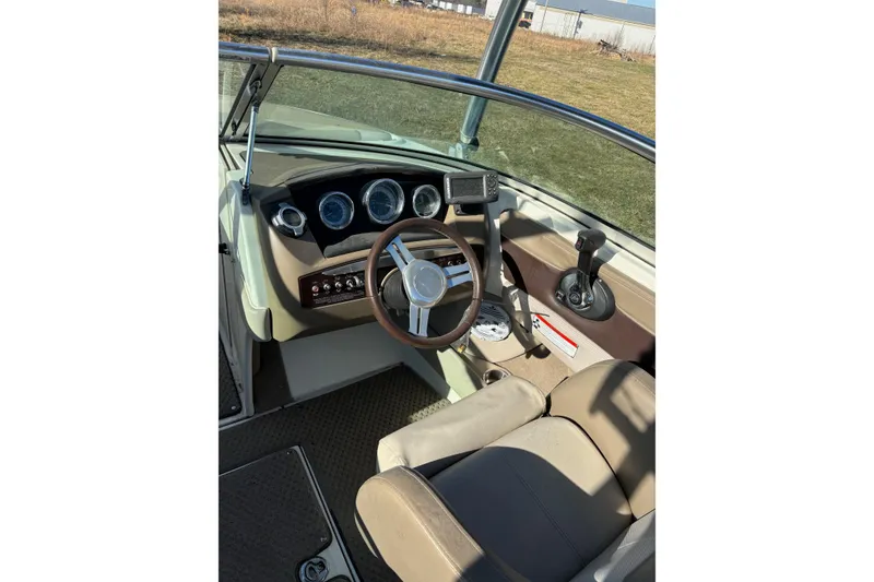 Slide: The Image of 2011 Sea Ray 210 SLX boat interior with steering wheel and dashboard controls. - 8