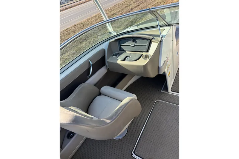 Slide: The Image of Interior of a 2011 Sea Ray 210 SLX boat, featuring a comfortable captain's chair. - 9