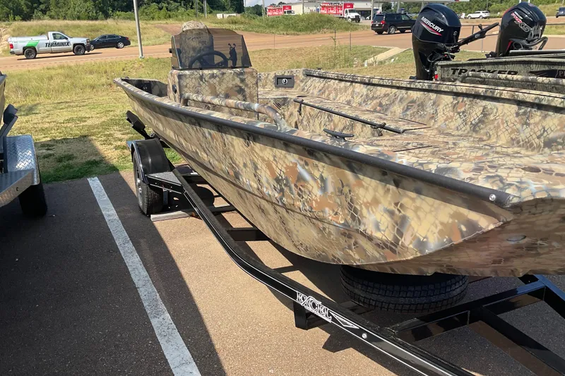 Slide: The Image of 2025 Excel 1751 River Warrior boat with camouflage design on a trailer. - 4