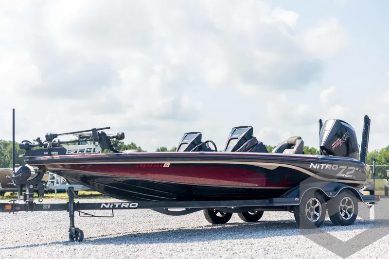 The Image of 2020 Nitro Z21 boat on trailer, sleek design, parked outdoors under cloudy sky. - 1