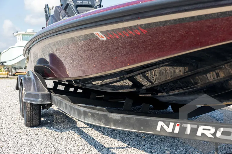 Slide: The Image of 2020 Nitro Z21 boat on trailer, parked on gravel, close-up view. - 10