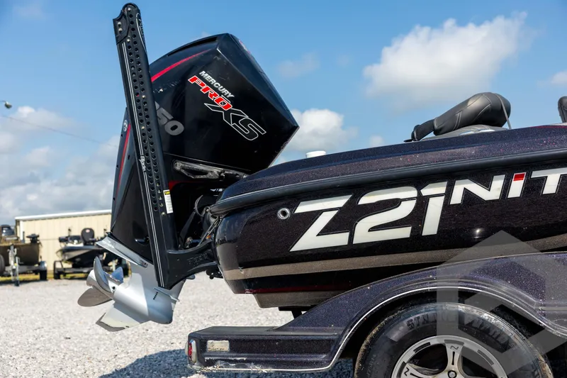 Slide: The Image of 2020 Nitro Z21 boat with Mercury Pro XS engine, parked on gravel under a blue sky. - 15