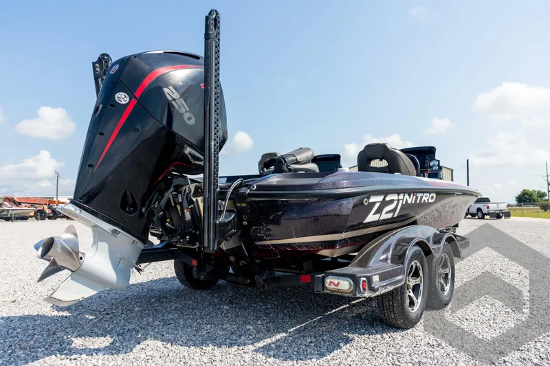 Slide: The Image of 2020 Nitro Z21 boat with powerful engine, parked on gravel under clear sky. - 16