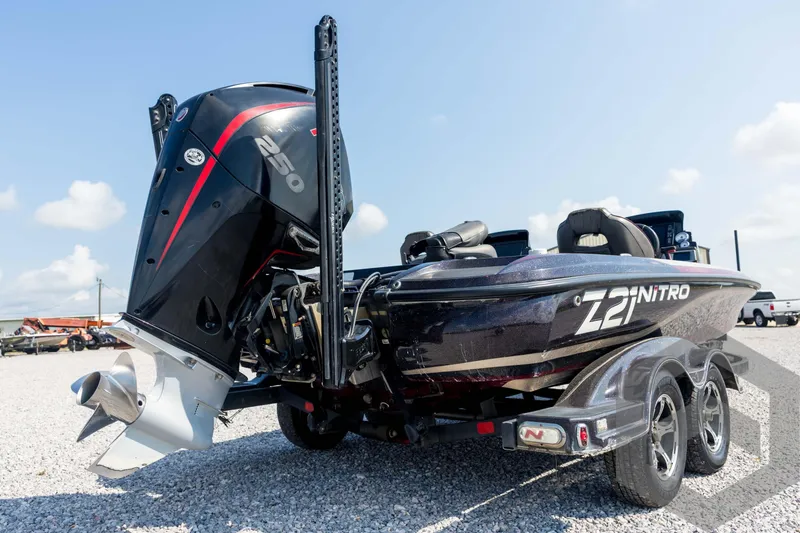 Slide: The Image of 2020 Nitro Z21 boat with powerful 250 engine, parked on gravel under clear sky. - 19
