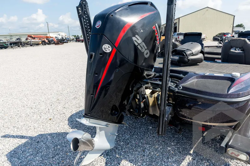 Slide: The Image of 2020 Nitro Z21 boat with powerful 250 horsepower outboard motor in a gravel lot. - 21