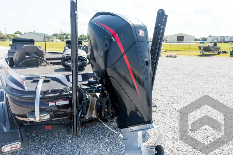 Slide: The Image of 2020 Nitro Z21 boat with powerful outboard motor in a gravel lot. - 23