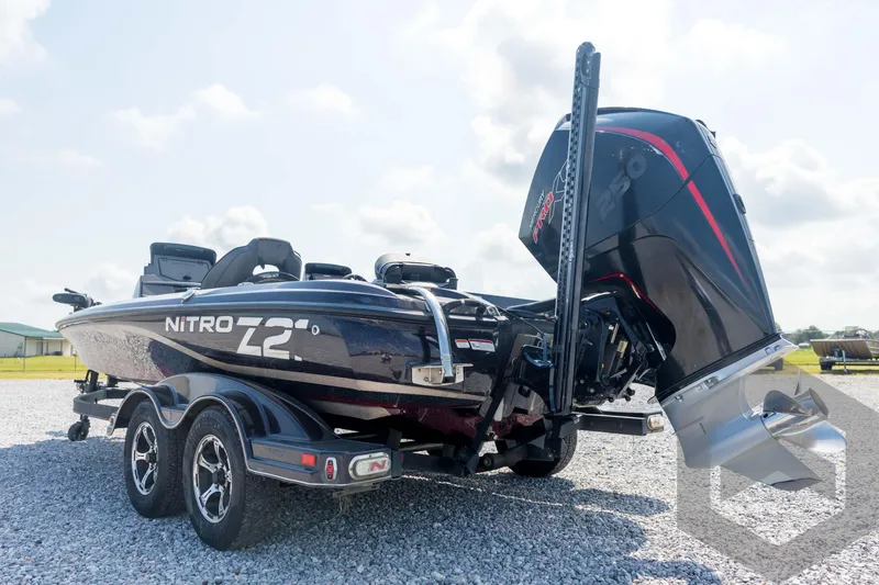 Slide: The Image of 2020 Nitro Z21 boat with powerful outboard motor on a gravel lot. - 27