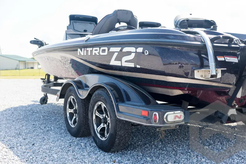 Slide: The Image of 2020 Nitro Z21 boat on trailer, parked on gravel, side view. - 28