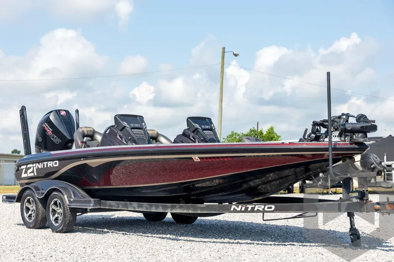 Slide: The Image of 2020 Nitro Z21 boat on trailer, sleek design, dual engines, parked outdoors. - 3