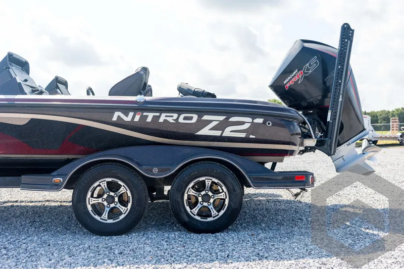 Slide: The Image of 2020 Nitro Z21 boat on trailer with Mercury Pro XS engine, parked on gravel. - 30