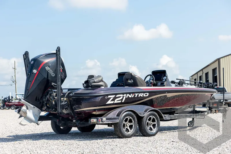 Slide: The Image of 2020 Nitro Z21 boat on trailer, parked outdoors under a clear sky. - 5