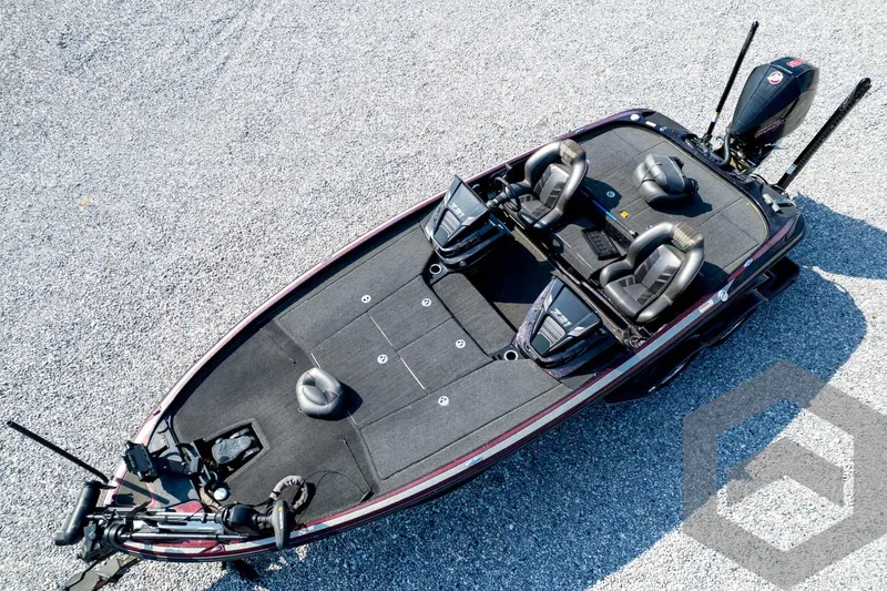 Slide: The Image of 2020 Nitro Z21 bass boat, aerial view, on gravel surface, featuring dual seats and motor. - 73
