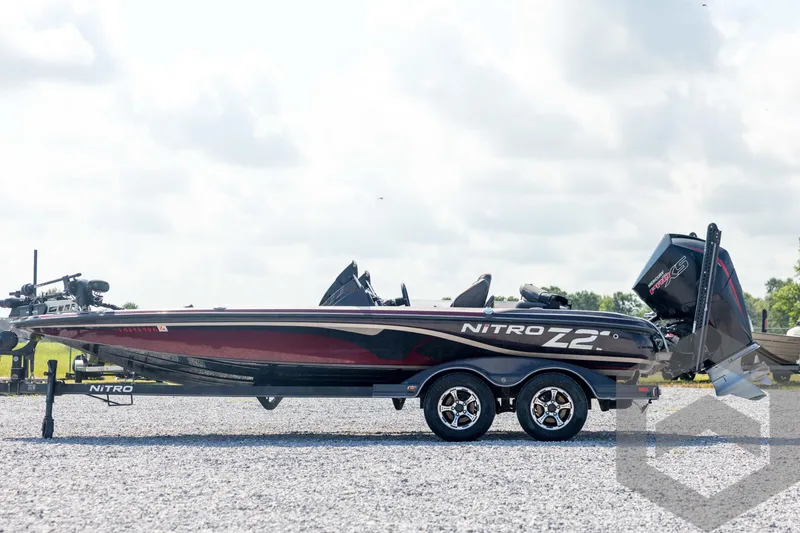 Slide: The Image of 2020 Nitro Z21 boat on trailer, side view, outdoors on gravel surface. - 8