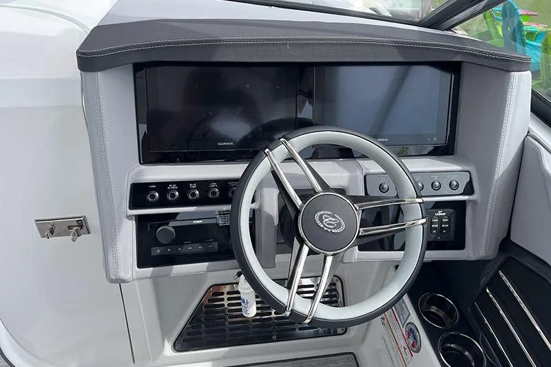 Slide: The Image of 2024 Cobalt A29 boat dashboard with steering wheel and dual display screens. - 4