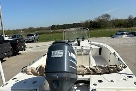 Slide: The Image of 2007 Scout 200 Bay Scout boat with Yamaha 115 engine, parked outdoors. - 3