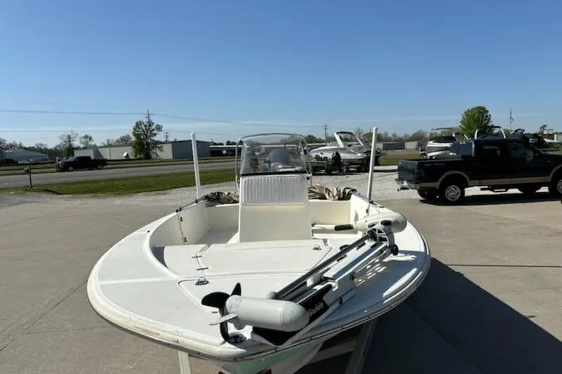 Slide: The Image of 2007 Scout 200 Bay Scout boat parked outdoors on a sunny day. - 4
