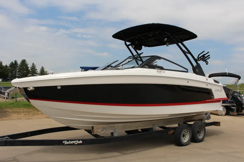 Slide: The Image of 2024 Cobalt R4 Surf boat on trailer, black and white design, outdoor setting. - 1