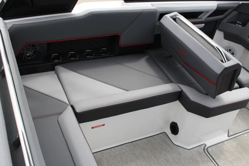 Slide: The Image of 2024 Cobalt R4 Surf boat interior with sleek gray seating and red accents. - 12