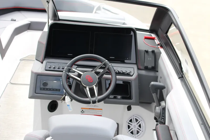 Slide: The Image of 2024 Cobalt R4 Surf boat dashboard with steering wheel and dual screens. - 13