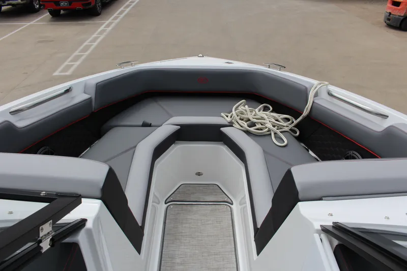 Slide: The Image of 2024 Cobalt R4 Surf boat interior with gray seating and coiled rope. - 17