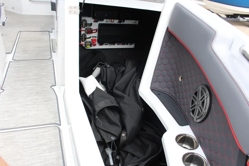Slide: The Image of 2024 Cobalt R4 Surf boat interior storage with speaker and cup holders. - 20