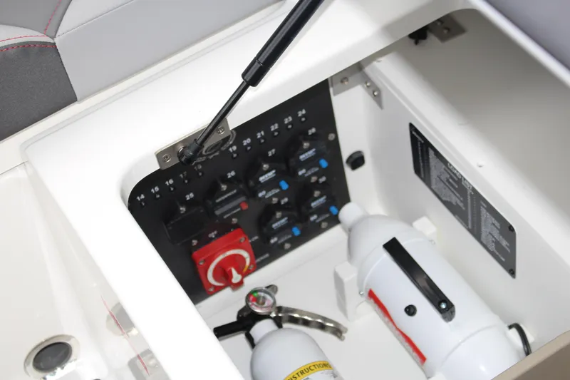 Slide: The Image of 2024 Cobalt R4 Surf boat interior with control panel and fire extinguisher. - 24