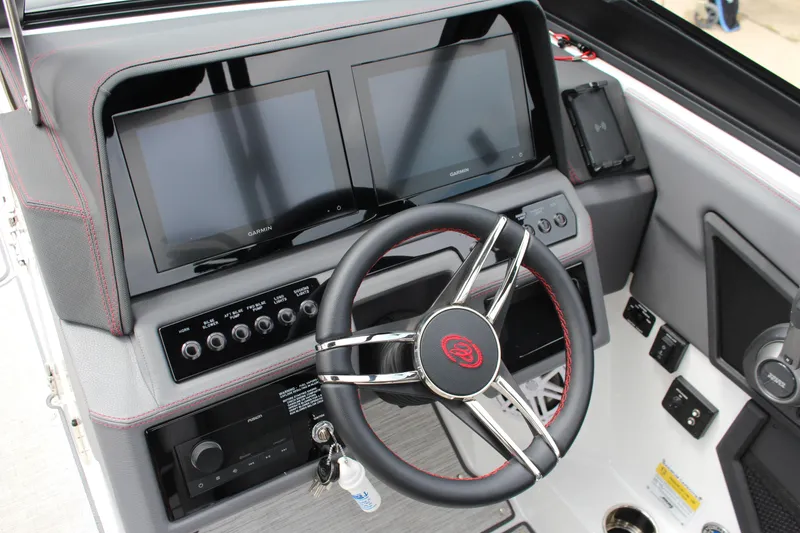 Slide: The Image of 2024 Cobalt R4 Surf boat dashboard with dual screens and modern steering wheel. - 26