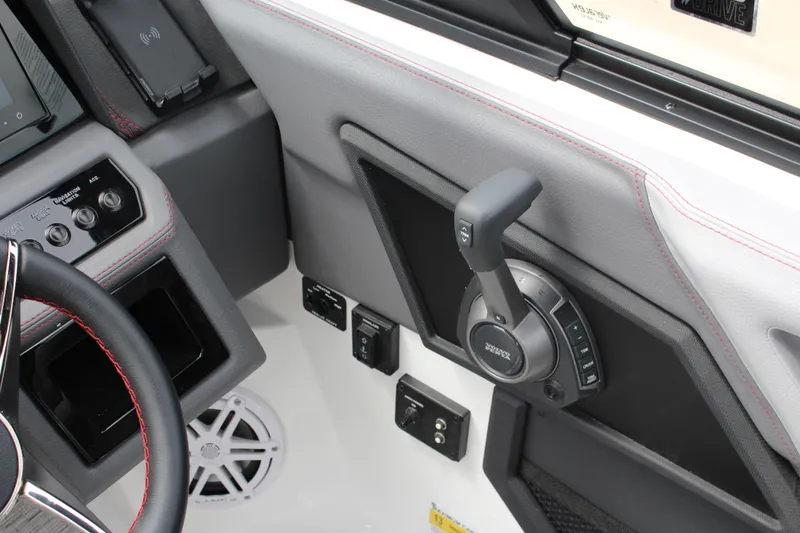 Slide: The Image of 2024 Cobalt R4 Surf boat dashboard with steering wheel and control panel. - 27