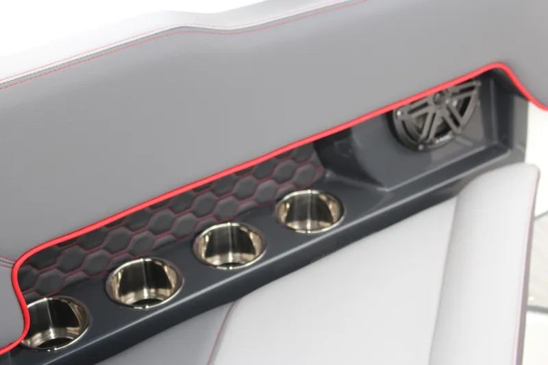 Slide: The Image of 2024 Cobalt R4 Surf interior with cup holders and speaker, featuring red accents. - 31