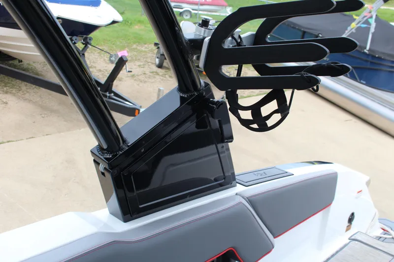 Slide: The Image of 2024 Cobalt R4 Surf boat with wakeboard rack and sleek interior design. - 32