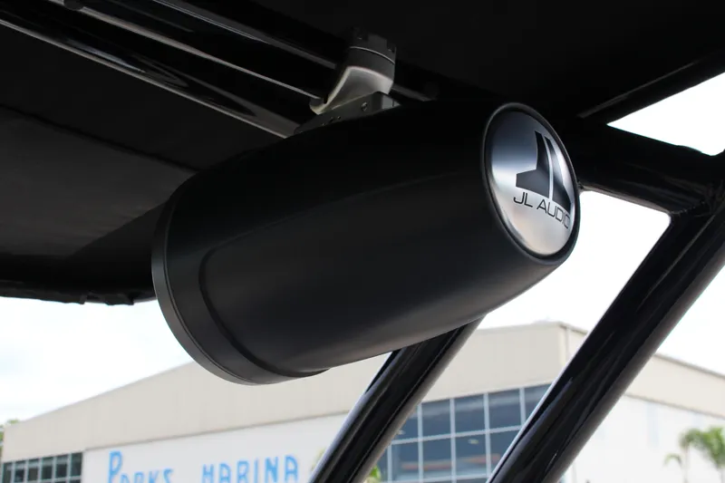 Slide: The Image of 2024 Cobalt R4 Surf boat with JL Audio speaker system at marina. - 34