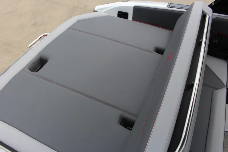 Slide: The Image of 2024 Cobalt R4 Surf boat interior with sleek gray seating and red stitching. - 40