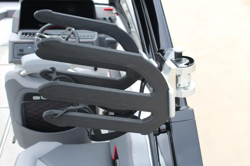 Slide: The Image of 2024 Cobalt R4 Surf boat interior with wakeboard rack and steering wheel. - 9