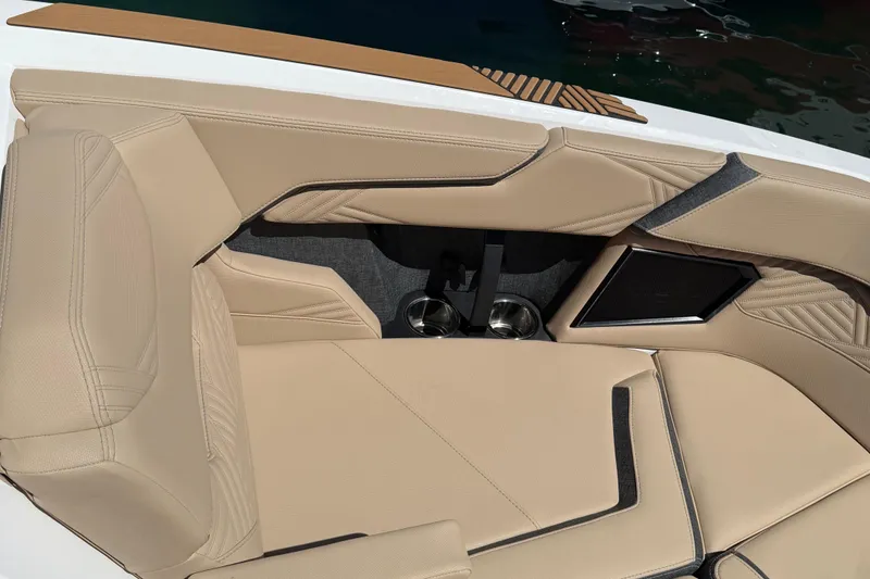 Slide: The Image of Luxurious seating on 2025 MasterCraft XStar 23 boat with beige upholstery and cup holders. - 11