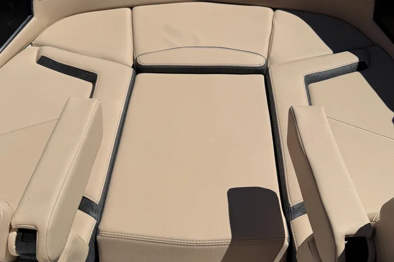 Slide: The Image of 2025 MasterCraft XStar 23 boat interior with beige cushioned seating. - 13
