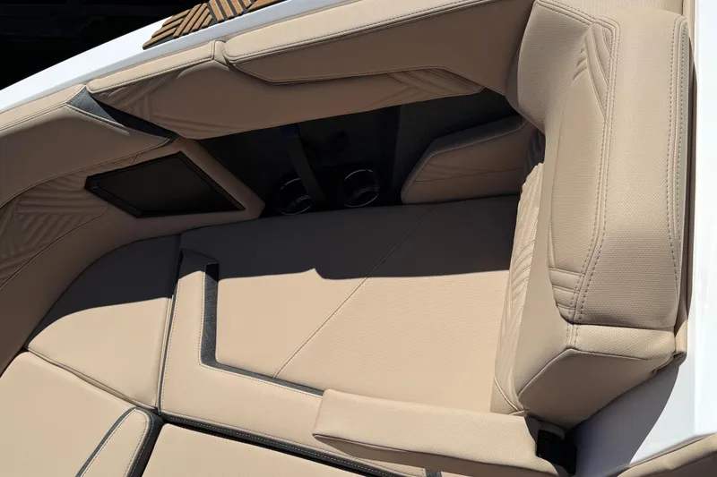 Slide: The Image of 2025 MasterCraft XStar 23 boat interior with beige cushioned seating. - 14