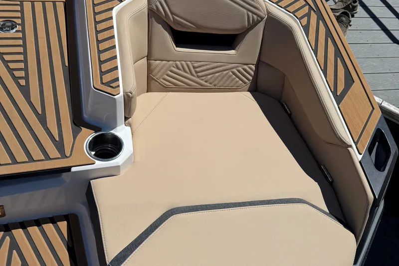 Slide: The Image of Luxurious seating area on 2025 MasterCraft XStar 23 boat with stylish upholstery and cup holder. - 15
