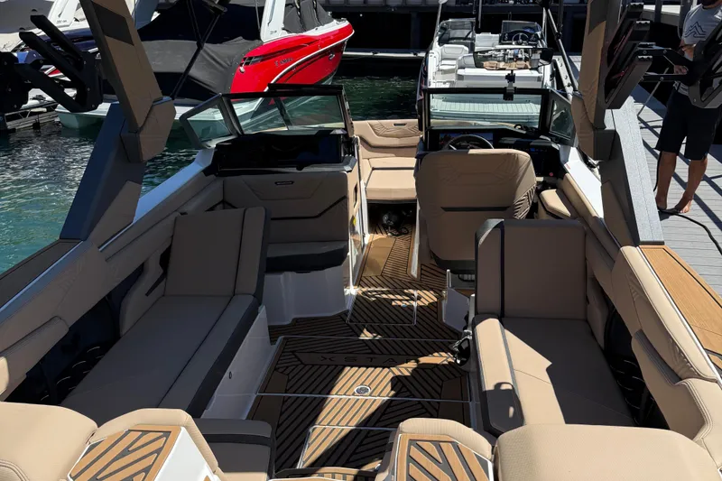 Slide: The Image of 2025 MasterCraft XStar 23 boat interior with beige seating and modern design. - 6
