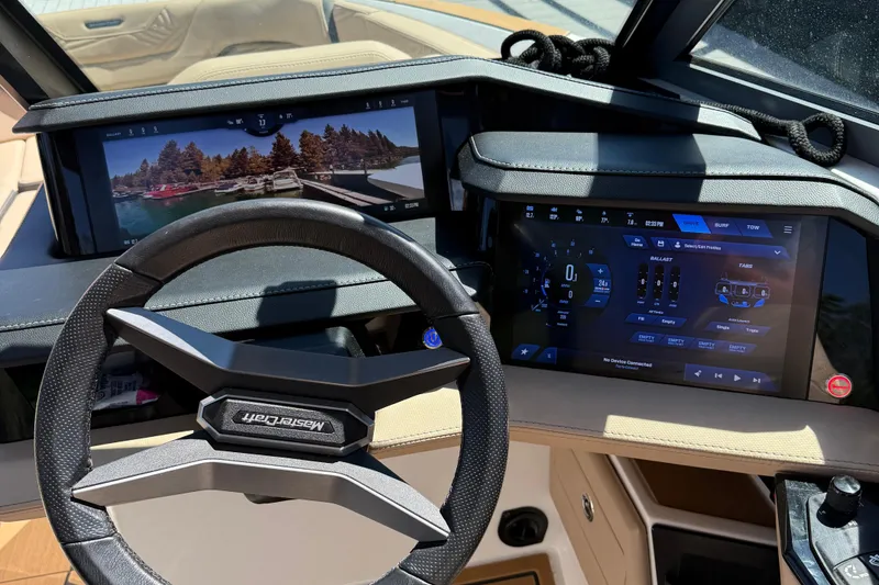 Slide: The Image of 2025 MasterCraft XStar 23 dashboard with advanced digital displays and steering wheel. - 7