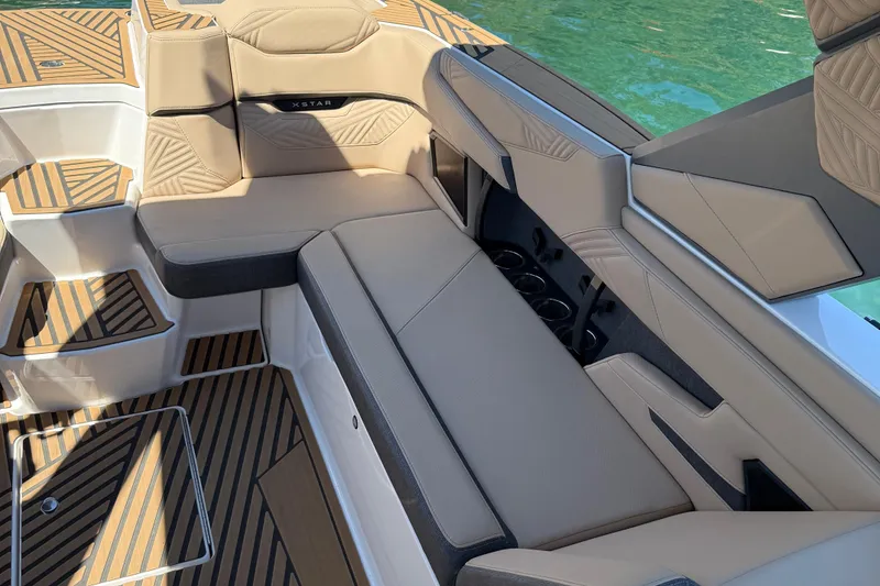 Slide: The Image of Luxurious interior of 2025 MasterCraft XStar 23 boat with beige seating and cup holders. - 9