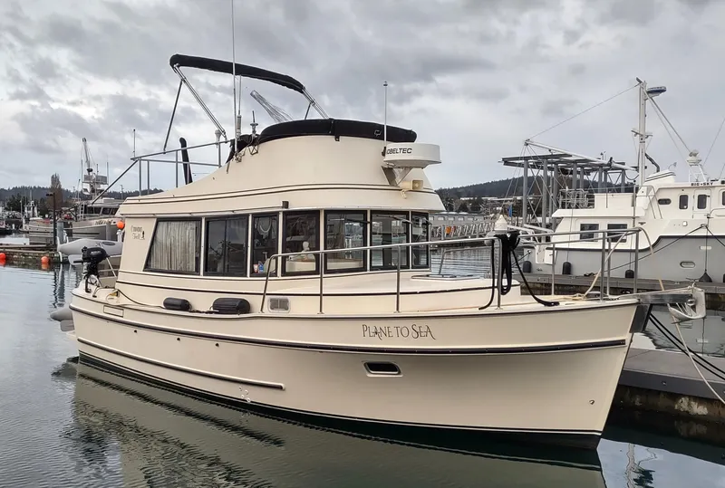 Slide: The Image of 2004 Camano Troll boat docked in a marina under cloudy skies. - 0