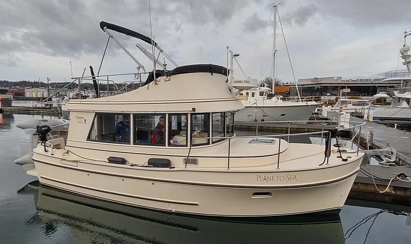 Slide: The Image of 2004 Camano Troll boat docked in a marina under cloudy skies. - 1