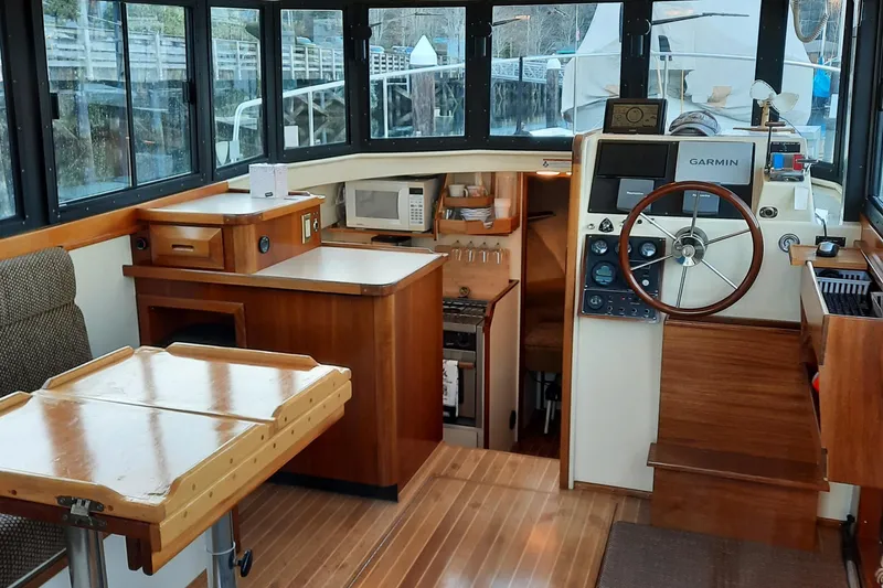 Slide: The Image of Interior of a 2004 Camano Troll boat with wooden furnishings and navigation equipment. - 12