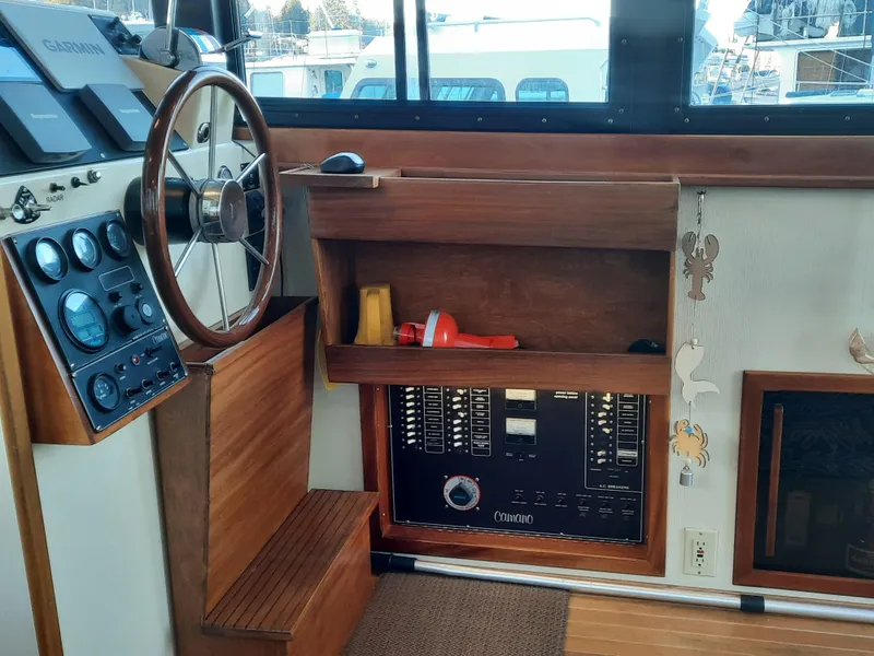 Slide: The Image of 2004 Camano Troll boat interior with steering wheel and control panel. - 15