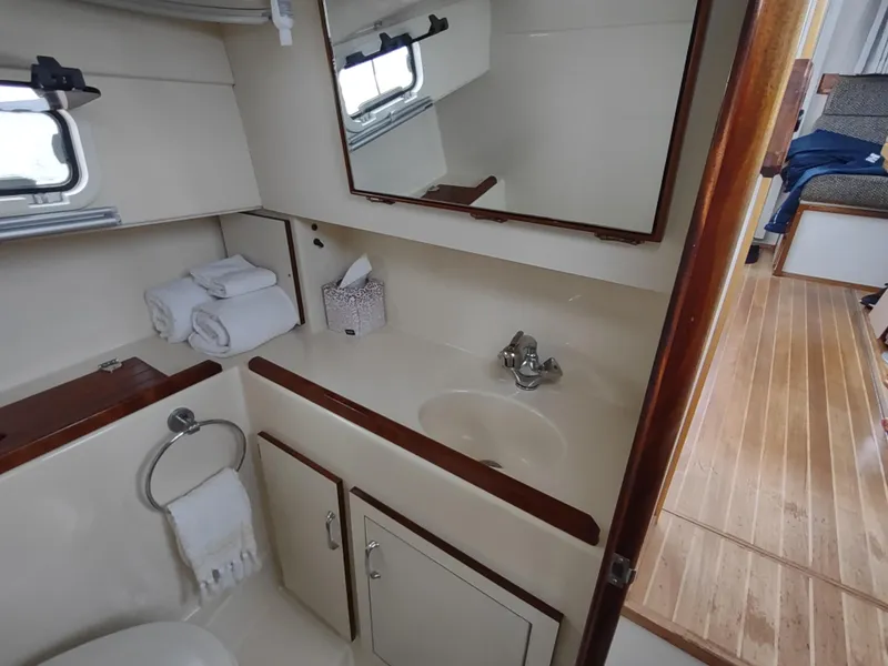 Slide: The Image of 2004 Camano Troll boat bathroom with sink, mirror, and wooden accents. - 29