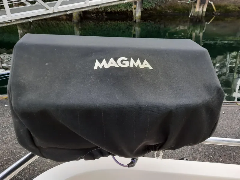 Slide: The Image of Magma grill cover on a 2004 Camano Troll boat, dockside view. - 32