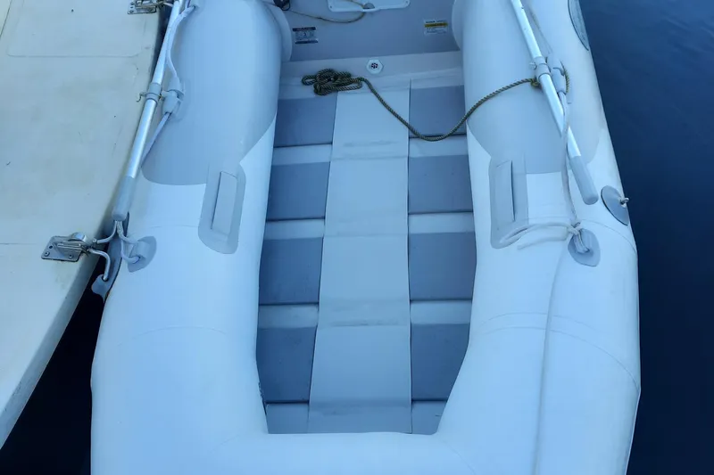 Slide: The Image of 2004 Camano Troll inflatable boat docked on calm water. - 33