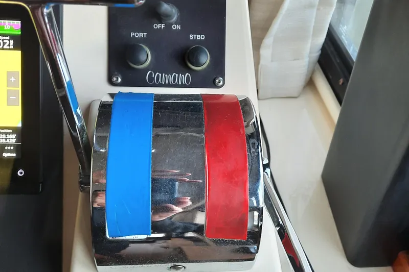 Slide: The Image of 2004 Camano Troll boat controls with blue and red throttle levers. - 35