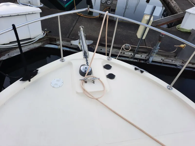 Slide: The Image of 2004 Camano Troll boat deck with railing and dock view. - 4