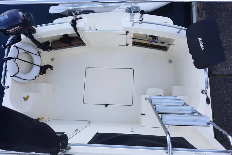 Slide: The Image of 2004 Camano Troll boat deck with storage compartments and ladder. - 7